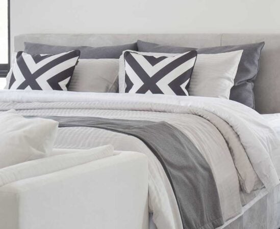Modern Gray tone bedding and bedside table and lamp in black