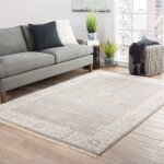 Lifestyle image of the Liberty Pelican Area Rug in a living room with a sofa.