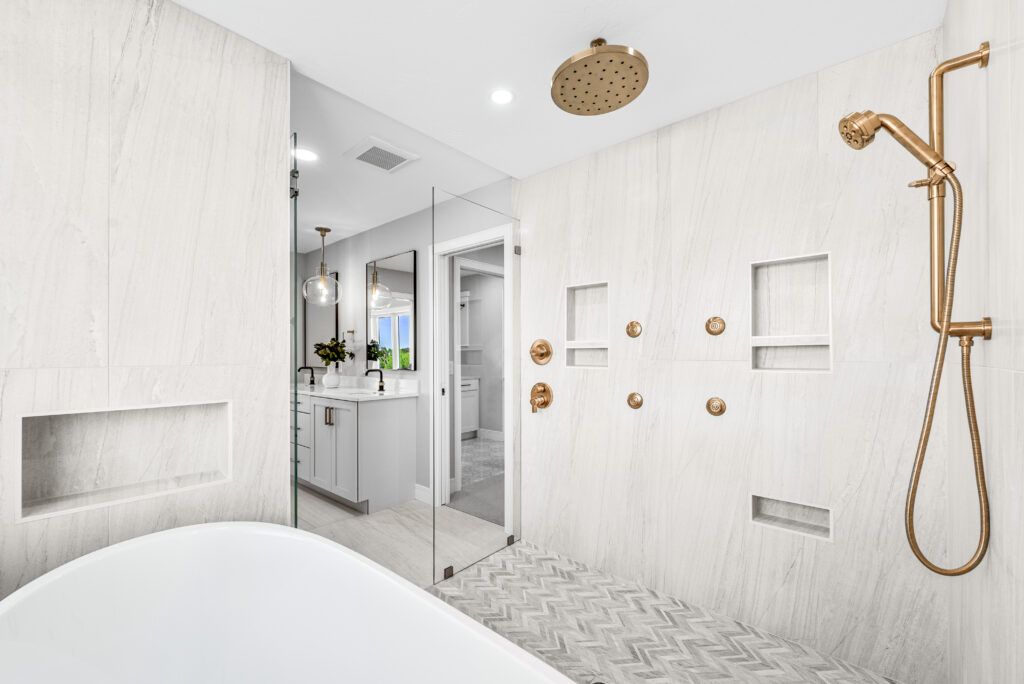 Tile work in the bathroom of a model home. Image shows tile on both the walls and floor.