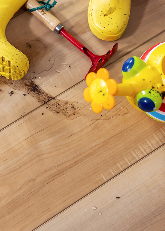 Waterproof Luxury Vinyl plank flooring with toys and water.